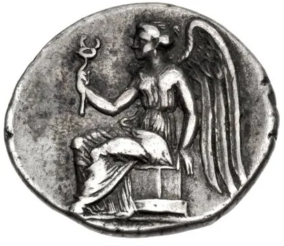 Immagine di moneta antica con figura femminile alata